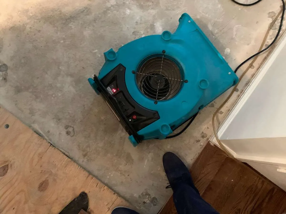 Air mover drying subfloor during Leak Detection & Repair in East Donegal